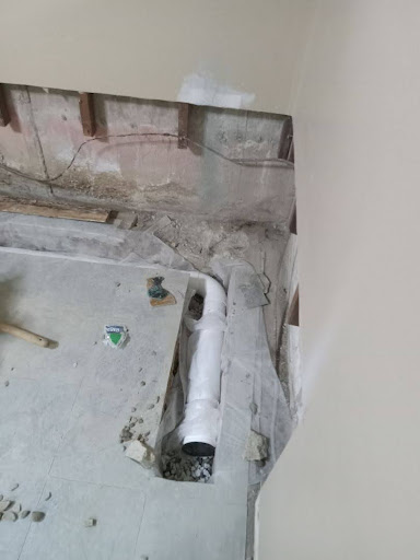 French drain installation in progress with the perforated pipe instllation.