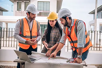 Three contractors discussing the strategy of a large commercial waterproofing project - 350