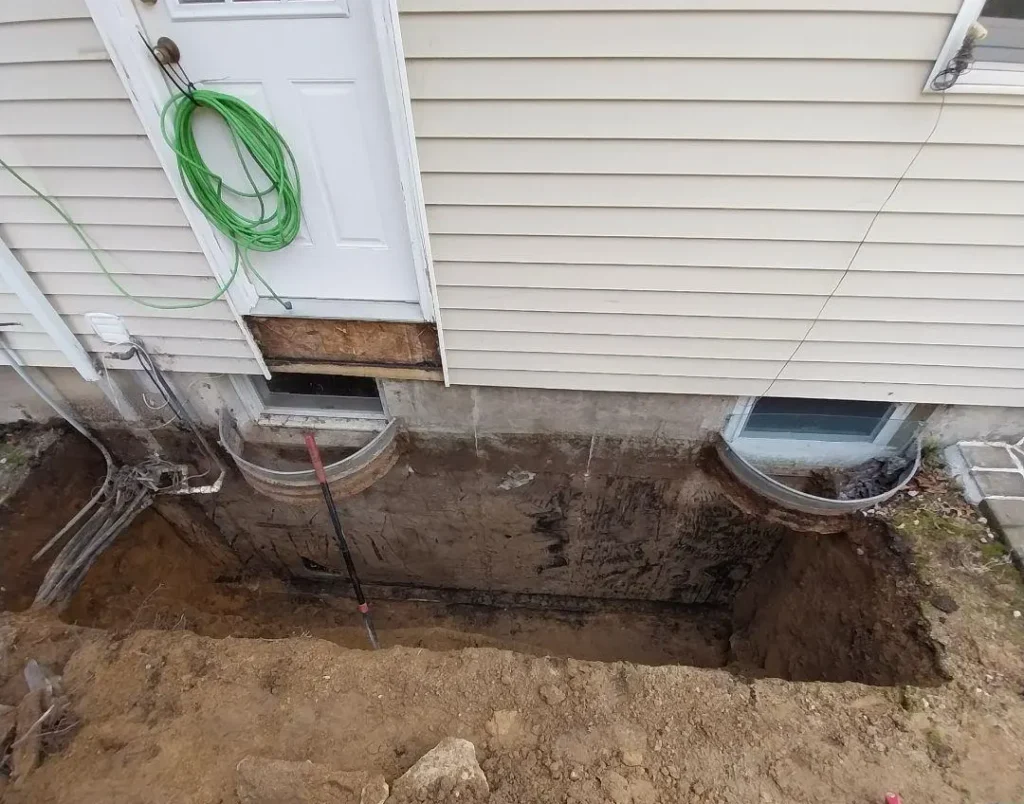 Foundation of a house dug up that requires foundation waterproofing