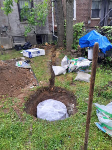An exterior french drain system being installed in the outdoors of a property