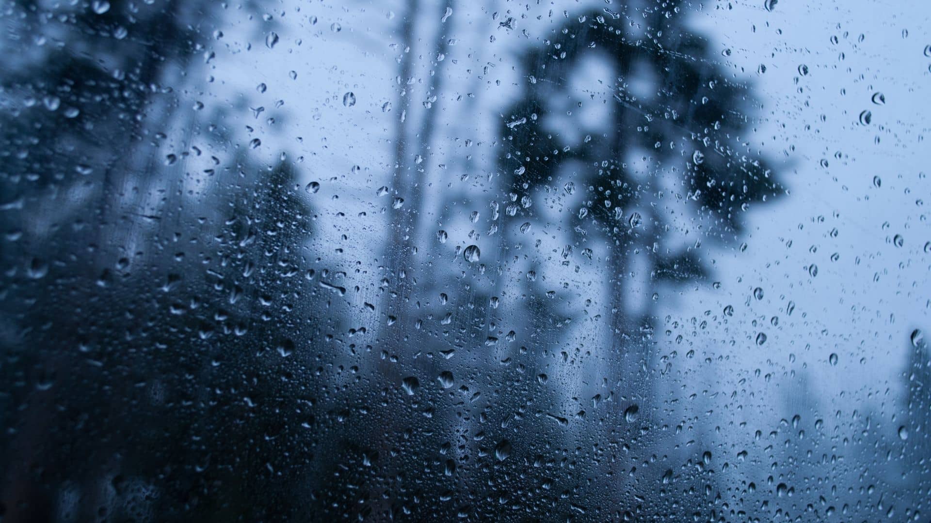 A window glass pane with water droplets showing high humidity in Long Island.