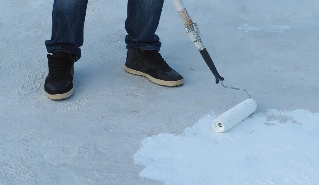 Waterproofing coating installation on a balcony with a roller