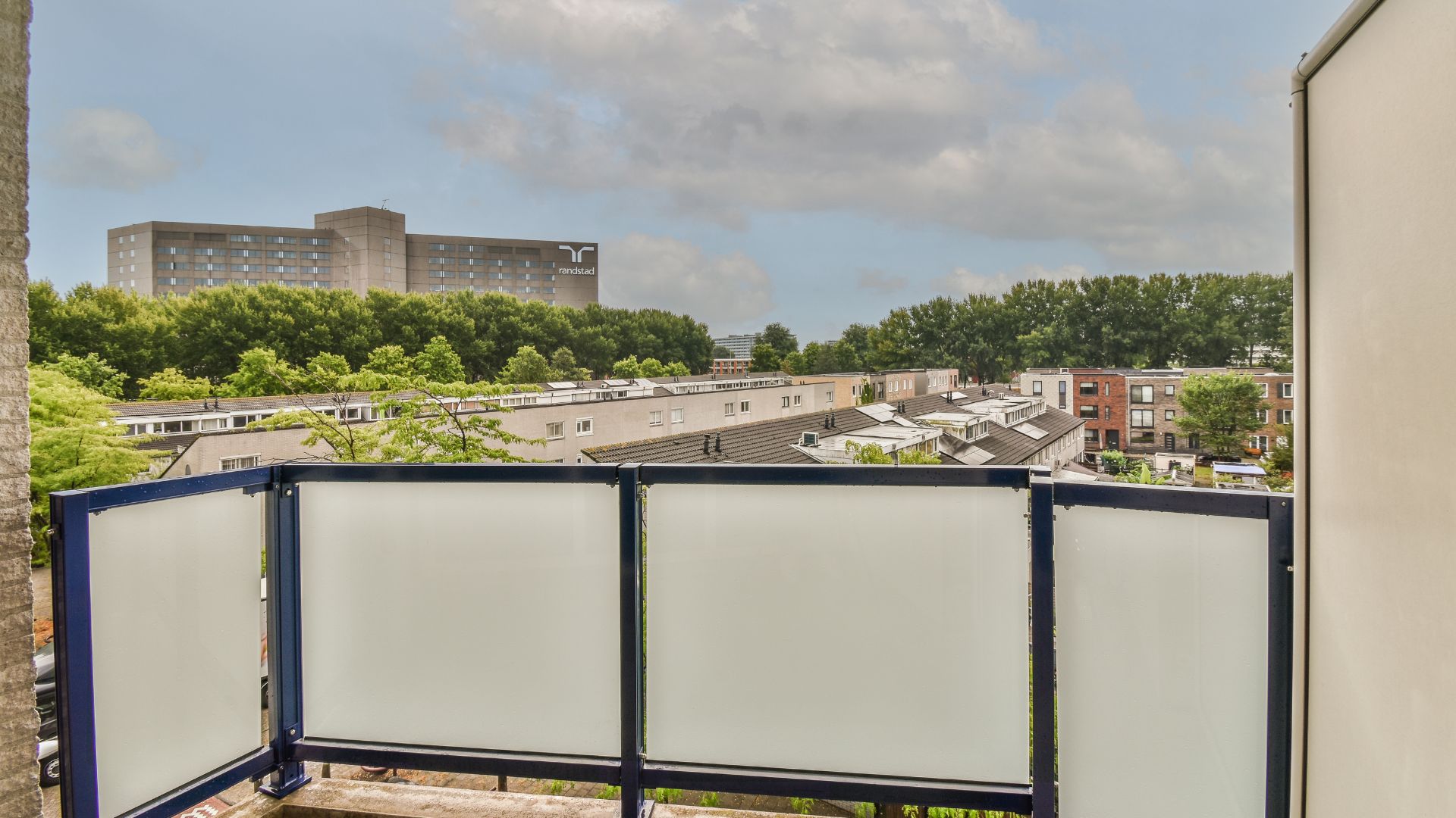 A balcony overlooking New York suburb skyline