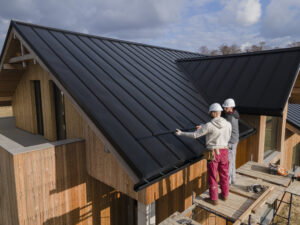 Two contractors looking at the roof they have to waterproof
