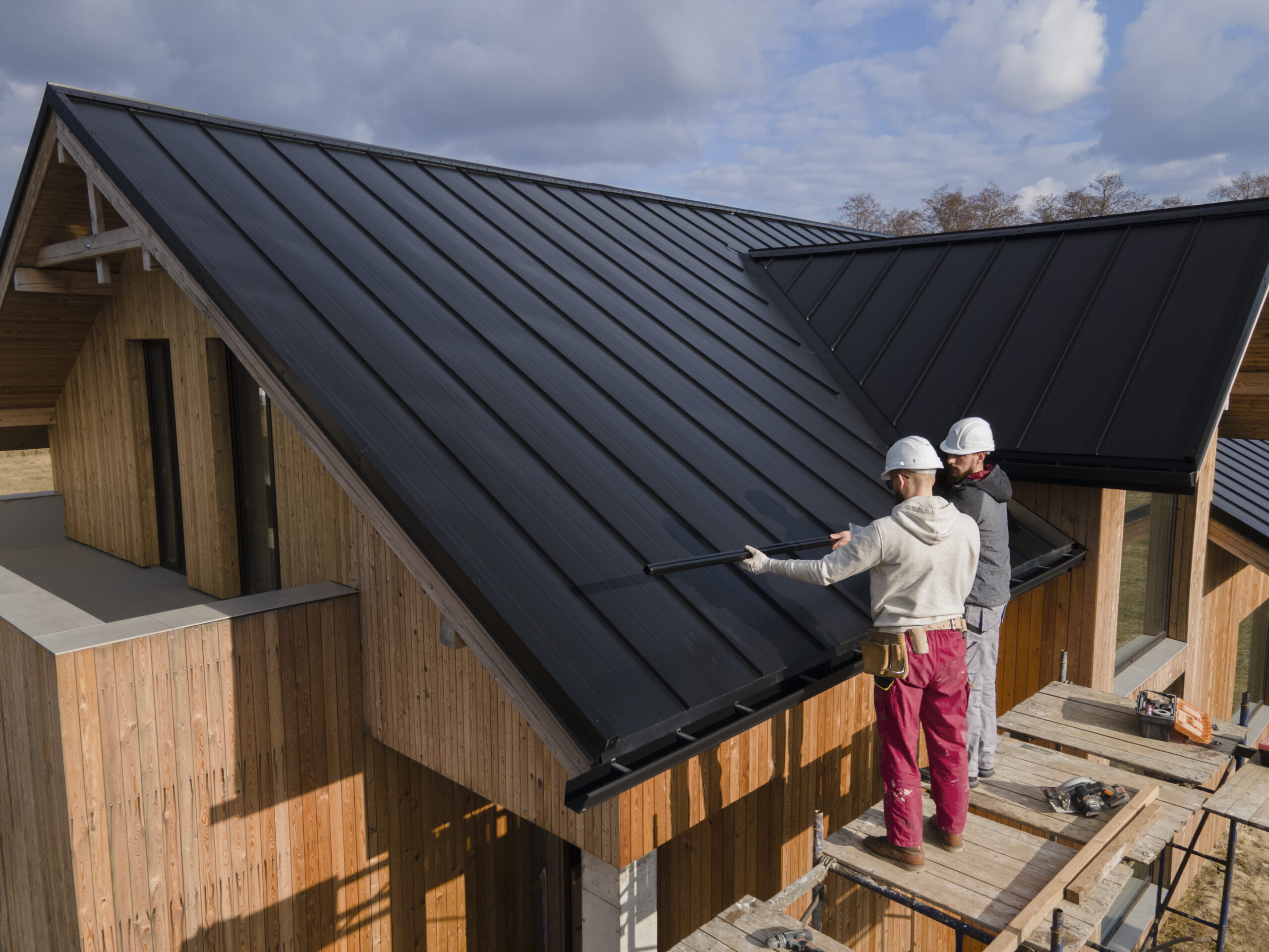 Two contractors looking at the roof they have to waterproof